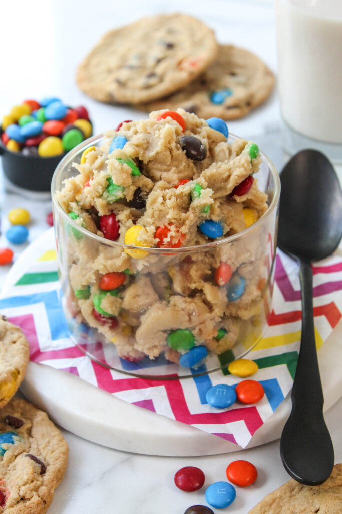 Close-up of soft cookie dough with colorful chocolate pieces
