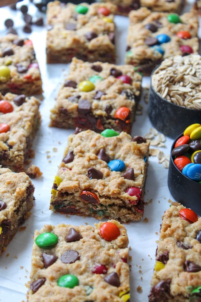 Thick and chewy monster cookie bars packed with oats, peanut butter, chocolate chips, and colorful M&Ms