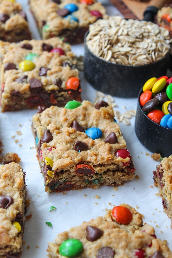Close‑up of monster cookie bars showing their gooey center and crisp golden edges