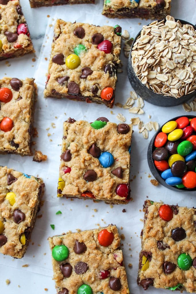 Freshly baked monster cookie bars cut into squares with visible oats and melted chocolate