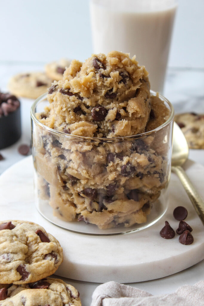 Edible chocolate chip cookie dough in a bowl with chocolate chips
