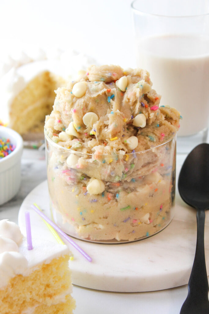 Edible birthday cake cookie dough with rainbow sprinkles and white chocolate chips in a bowl