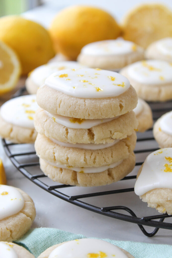 Stack of lemon meltaway cookies with lemon icing and fresh lemon zest