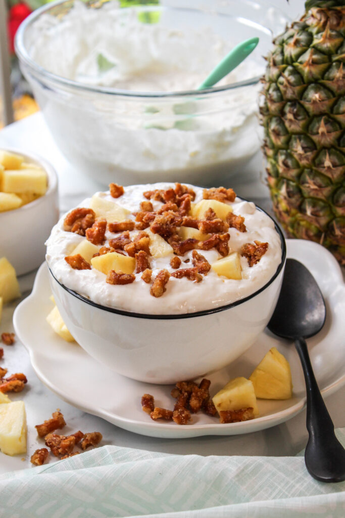 Creamy pineapple pretzel salad fluff served in a bowl, with juicy pineapple chunks and crunchy pretzel pieces folded into a light whipped mixture