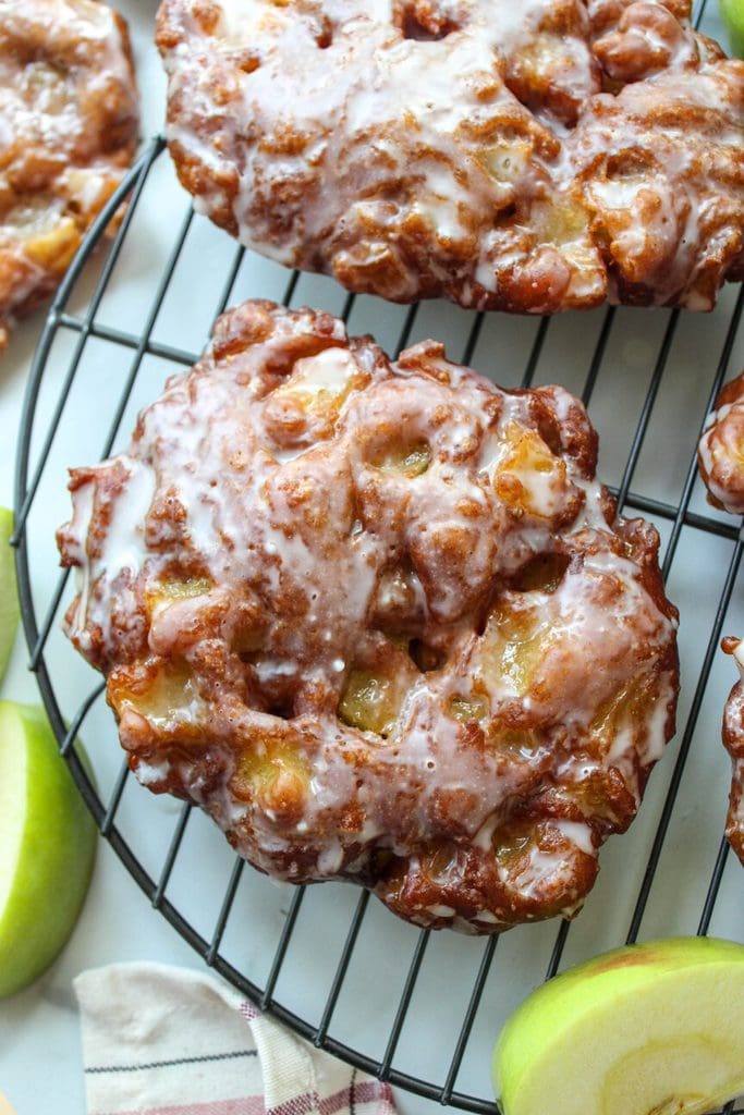 Fresh apple fritters with cinnamon spice and glossy glaze on top