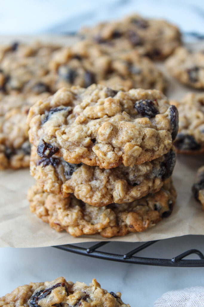 Freshly baked oatmeal raisin cookies on a cooling rack