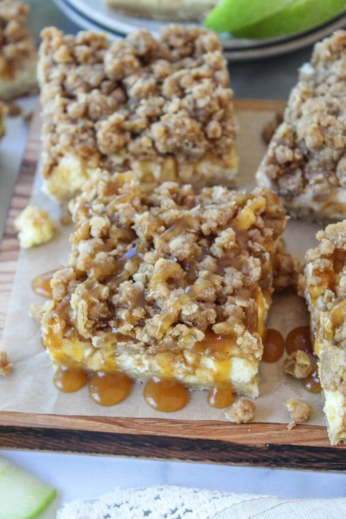 Close‑up of caramel apple cheesecake bars showing creamy cheesecake layers