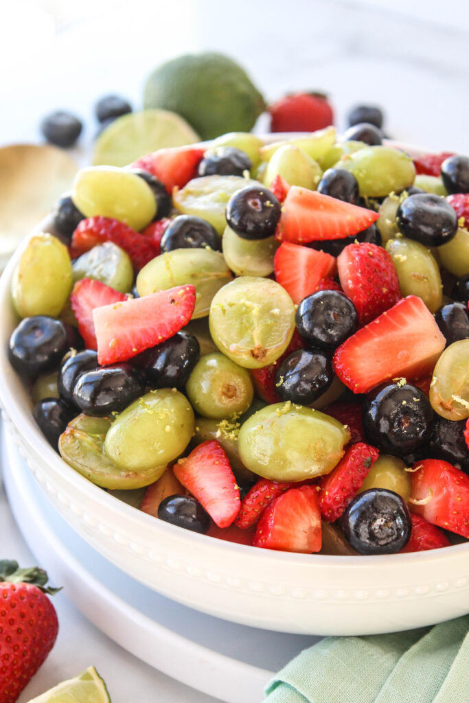 Honey lime fruit salad with grapes, strawberries, and blueberries