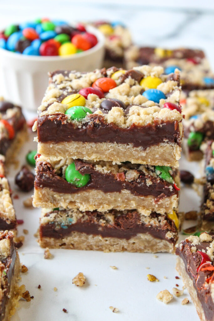 Homemade M&M chocolate bars with an oat crust, gooey chocolate center, and colorful candy topping
