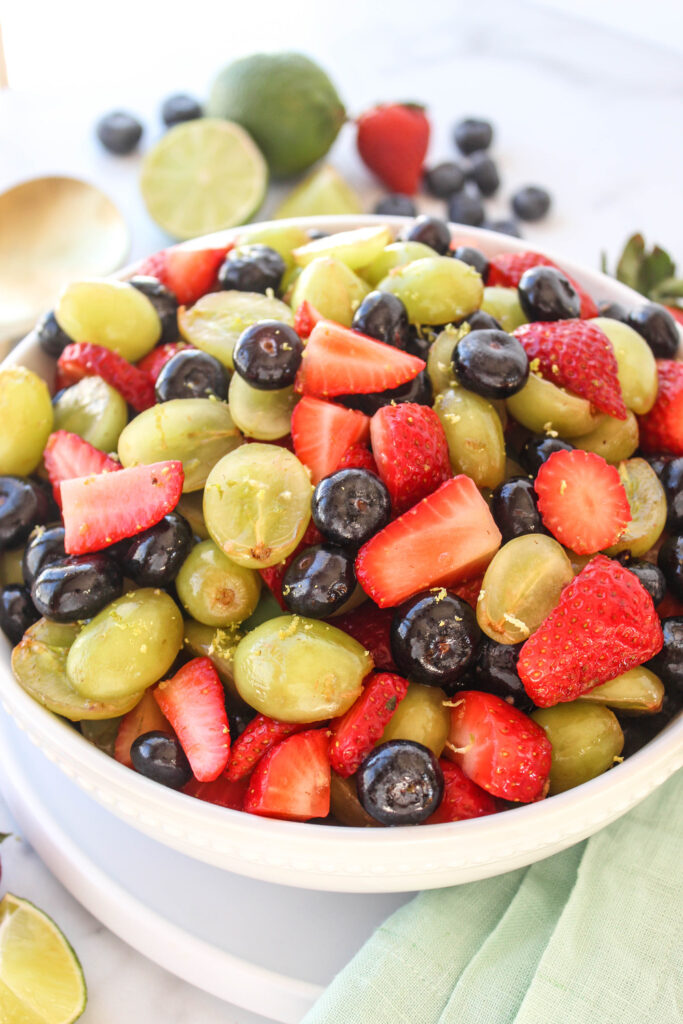 Close‑up of honey lime fruit salad coated in citrus dressing