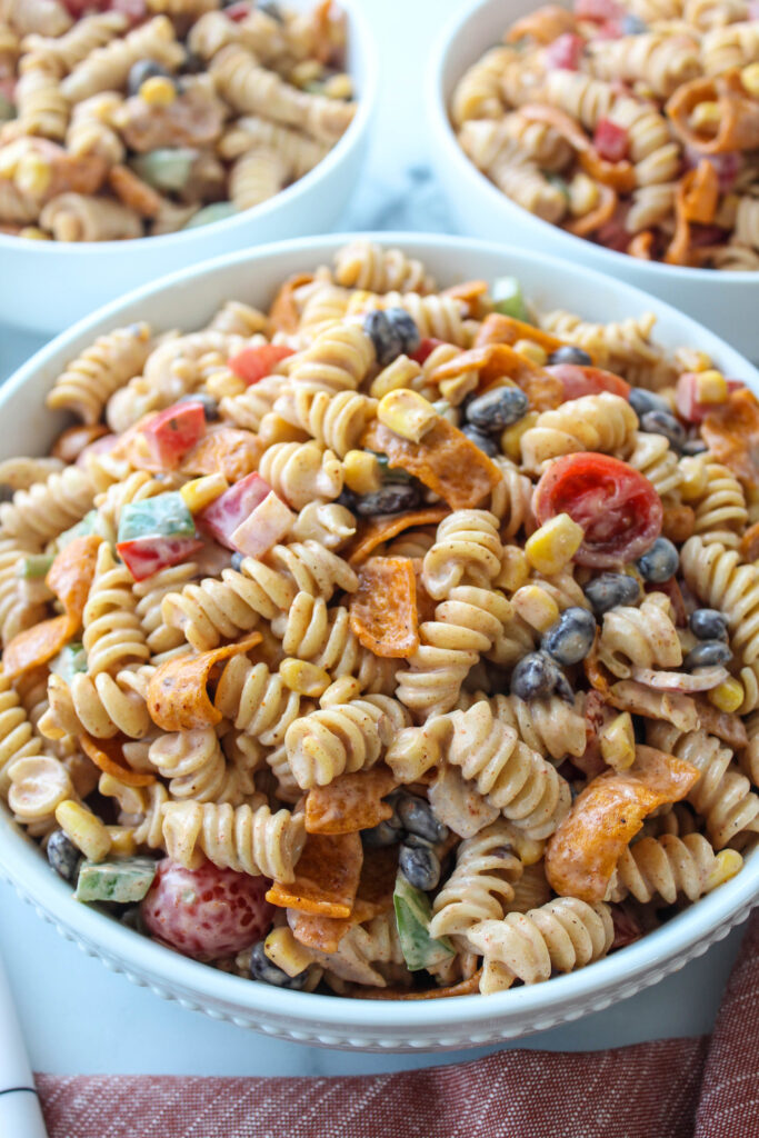 Close‑up of creamy ranch taco pasta salad showing rotini, beans, corn, and taco seasoning