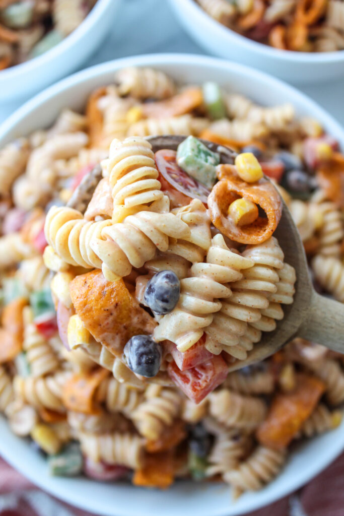 Bowl of ranch taco pasta salad with rotini pasta, bell peppers, black beans, and corn