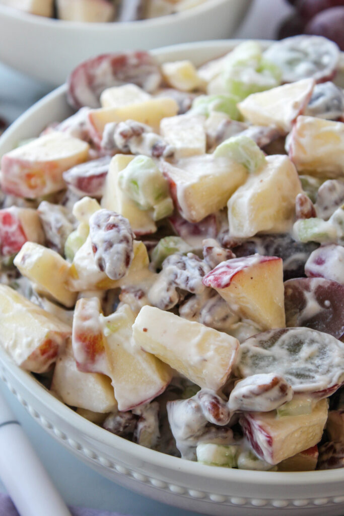 Homemade Waldorf salad with fruit and pecans mixed in a creamy dressing