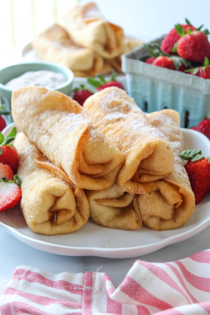 Golden fried strawberry cheesecake chimichangas dusted with cinnamon sugar
