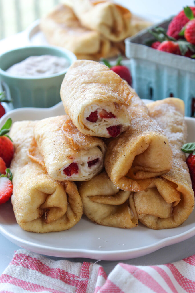 Crispy strawberry cheesecake chimichangas served on a plate