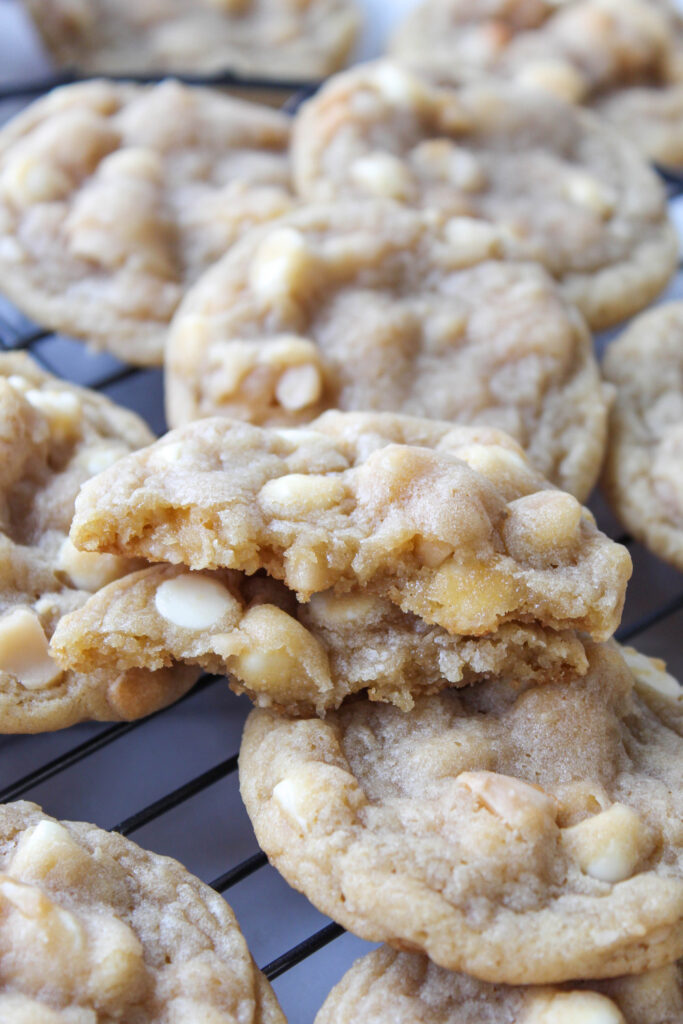 Close-up of soft and chewy white chocolate macadamia nut cookies with crisp edges and creamy chocolate chips
