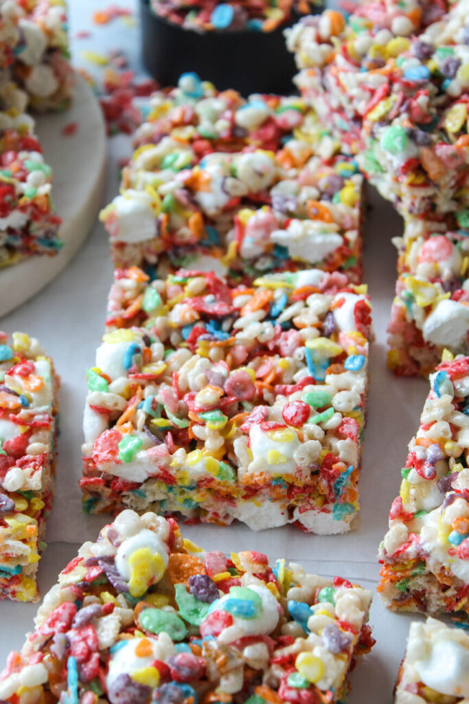 Close‑up of homemade Fruity Pebbles Rice Krispie treats with vibrant rainbow cereal
