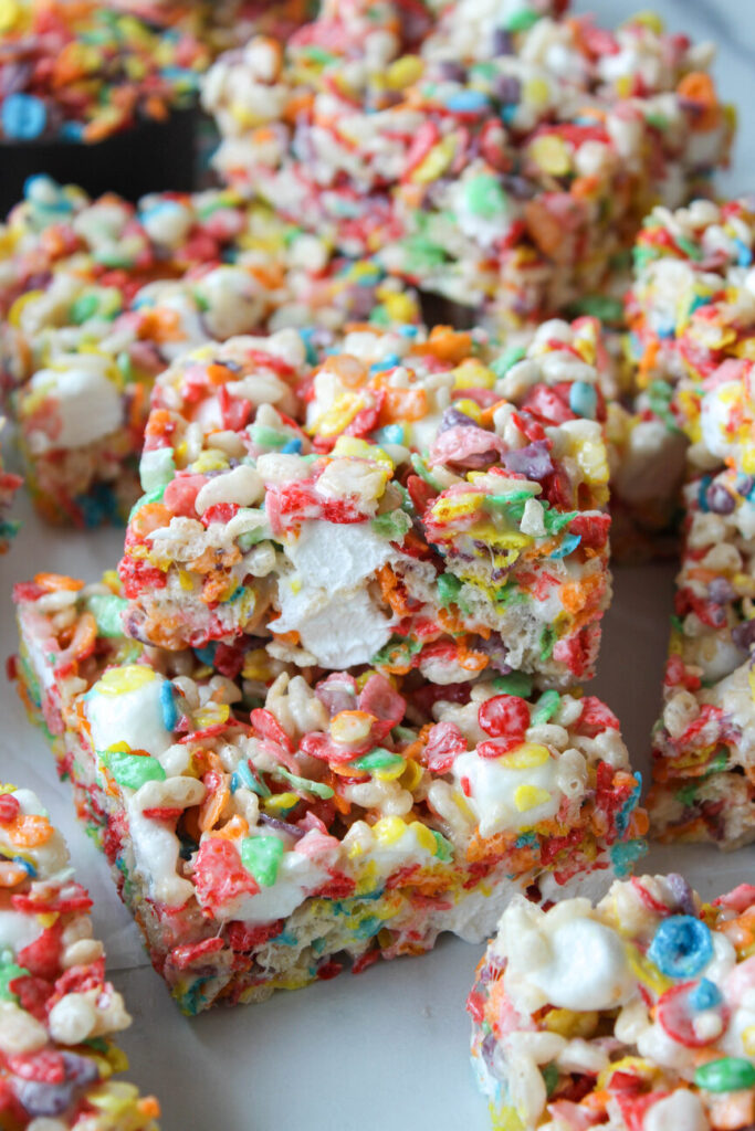 Easy homemade Fruity Pebbles Rice Krispie treats on parchment paper

