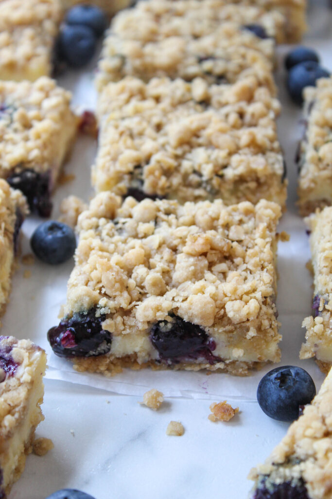 Blueberry crumble cheesecake bars cut into squares
