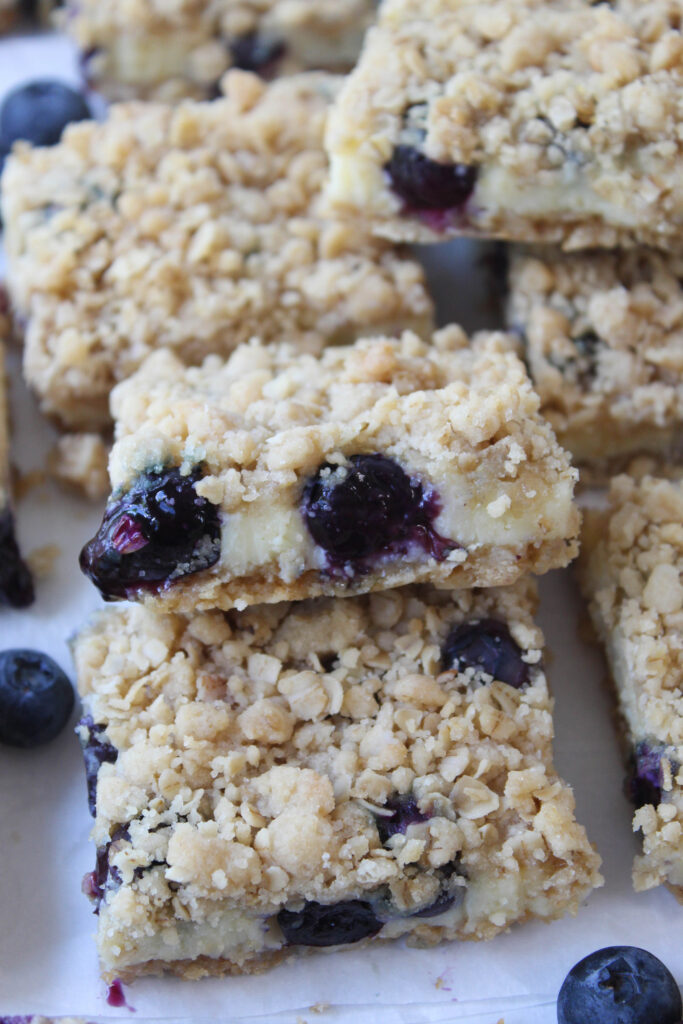 Blueberry crumble cheesecake bars with a creamy filling, buttery crust, and golden crumb topping
