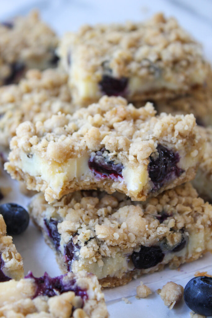 Blueberry cheesecake bars featuring a crumb crust, smooth cheesecake layer, and crisp streusel topping



