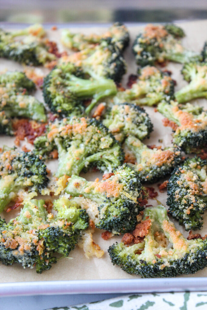 Golden-edged smashed broccoli seasoned and finished with parmesan cheese