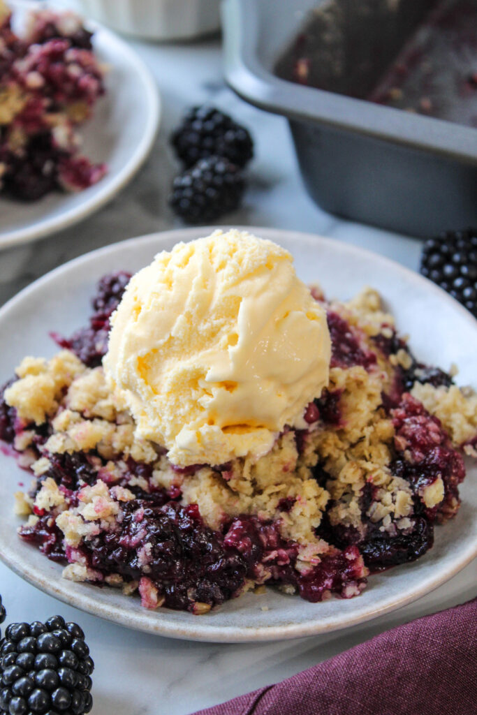 Simple blackberry crisp recipe served warm with vanilla ice cream