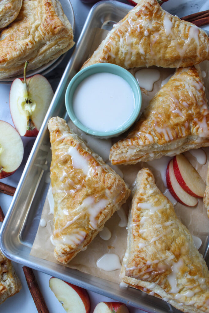 Freshly baked apple turnovers with puff pastry and a sweet vanilla glaze