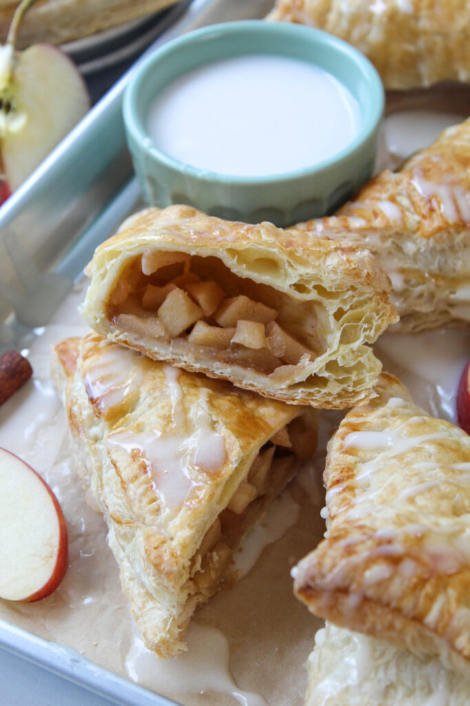 Close-up of a flaky apple turnover showing the cinnamon apple filling inside