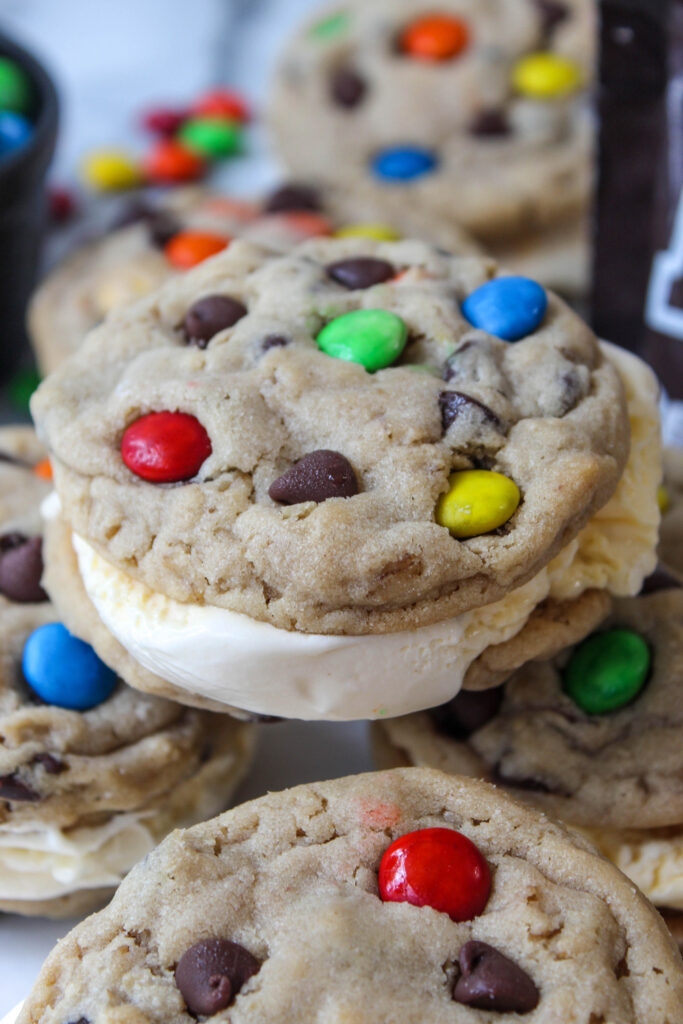 Close-up of a monster cookie ice cream sandwich showing creamy filling