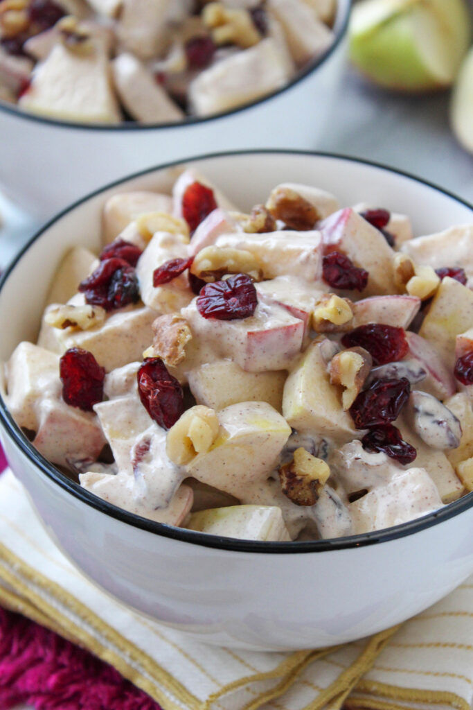 Homemade creamy apple cinnamon salad served in a white bowl