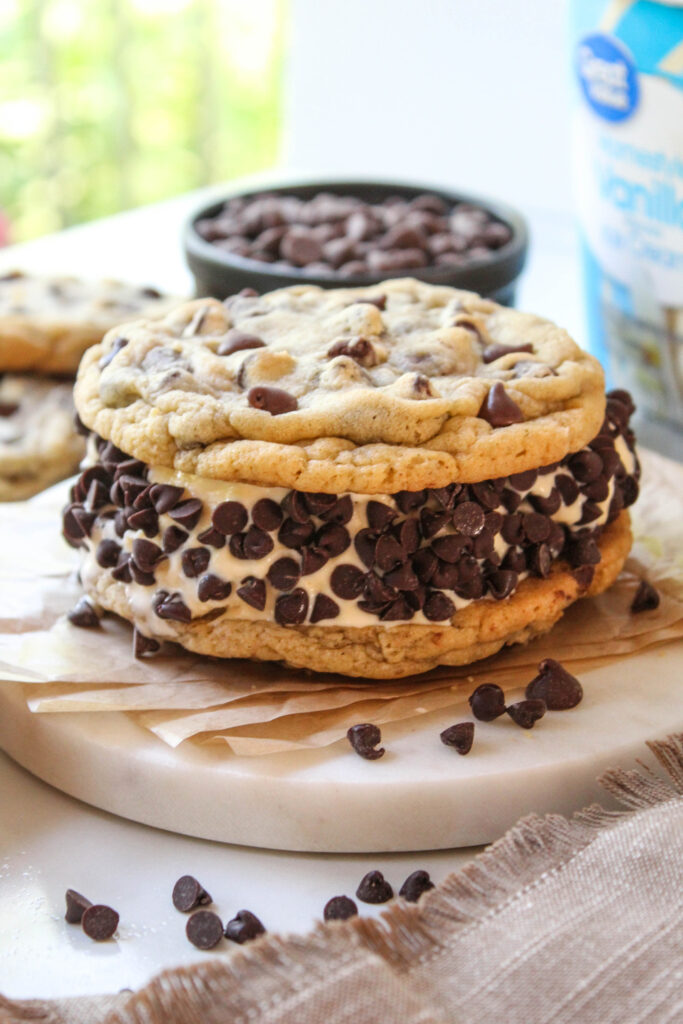 Thick vanilla ice cream between oversized chocolate chip cookies