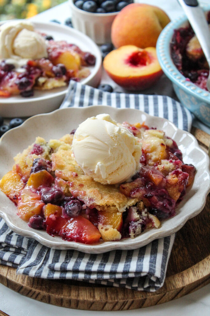 Peach blueberry cobbler with a golden, cake‑like topping and bubbling fruit filling