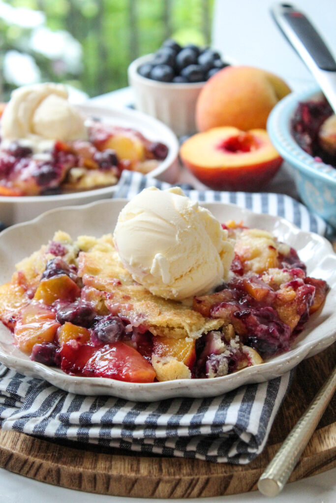 Close‑up of peach blueberry cobbler showing juicy peaches and burst blueberries