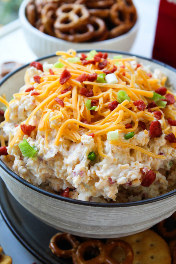 Close-up of creamy bacon ranch crack dip with cheddar cheese