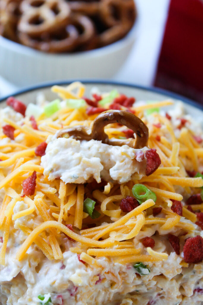 Close-up of creamy bacon ranch crack dip with cheddar cheese