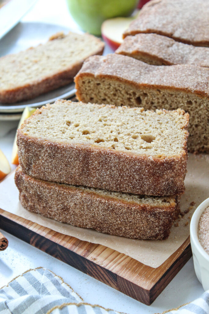 Cinnamon sugar apple cider bread served on a wooden cutting board