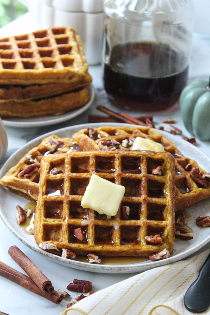 Pumpkin waffles made with canned pumpkin topped with butter and syrup