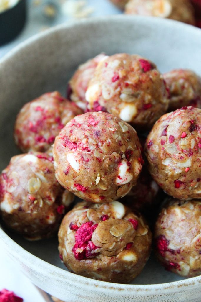 Healthy white chocolate raspberry snack balls with visible raspberry chunks