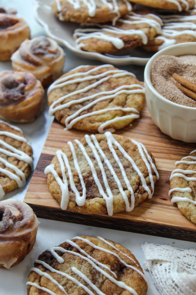 Freshly baked cinnamon roll cookies with a drizzle of glaze
