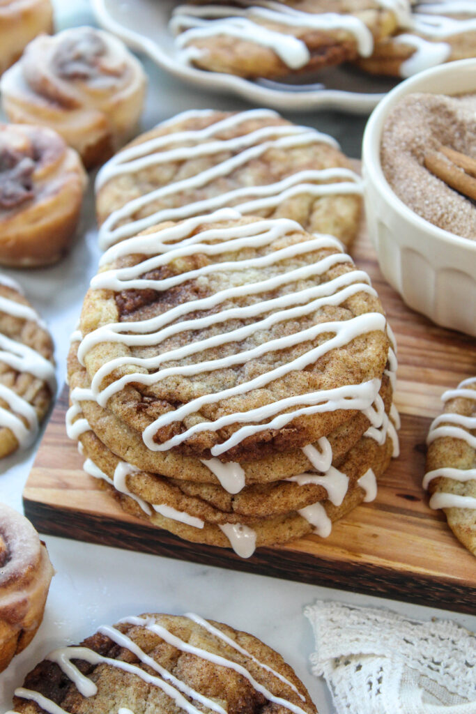 Close-up of fluffy cinnamon roll cookies featuring layers of cinnamon sugar and a creamy icing drizzle