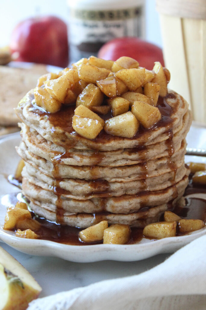Fluffy apple pancakes served with cinnamon, diced apples, and syrup