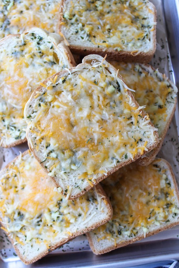 Thick Texas toast slices covered in buttery garlic spread and melted cheese