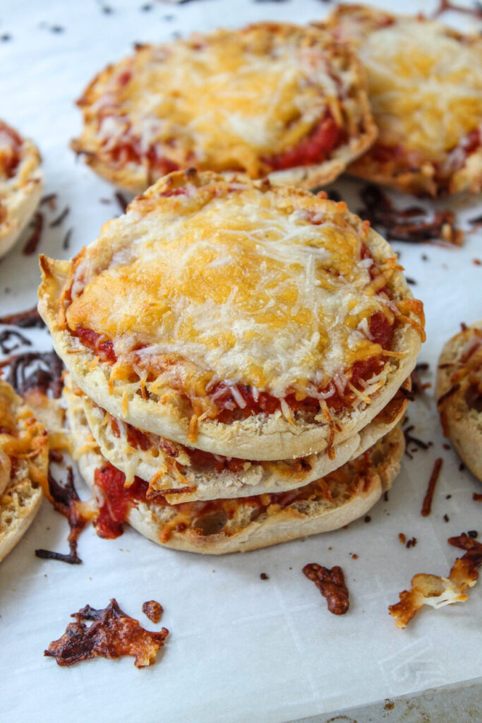 Cheese English muffin pizzas served on a baking sheet