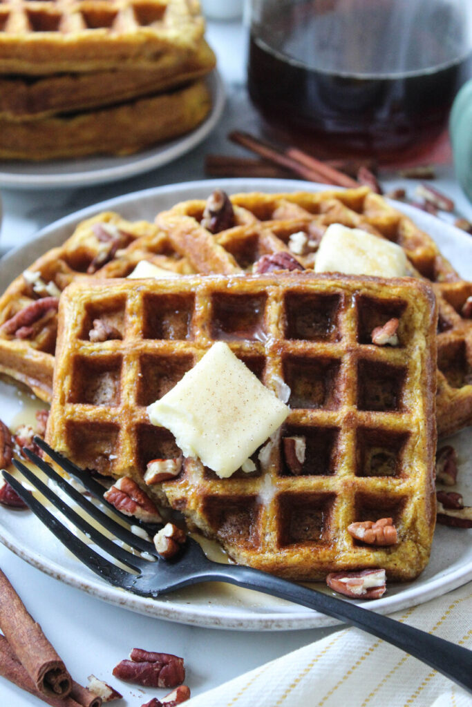 Homemade pumpkin waffles topped with butter and cinnamon sugar
