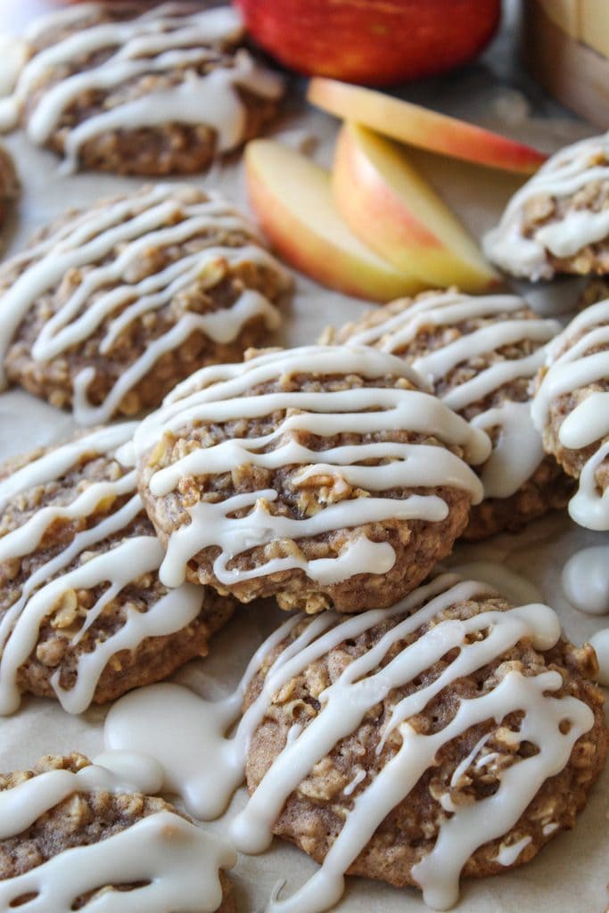 Overhead shot of apple cinnamon oatmeal cookies arranged on parchment paper
