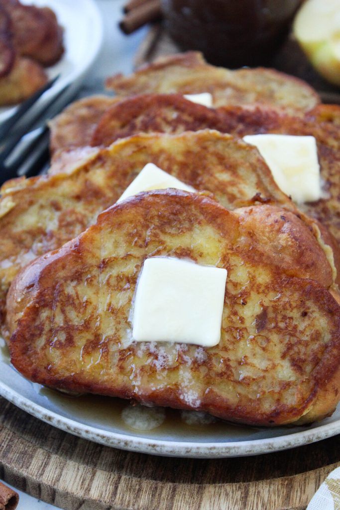 Golden apple butter French toast with crisp edges and a soft, custardy center