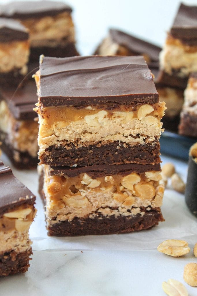 Fudgy chocolate brownies topped with nougat, peanuts, and glossy chocolate