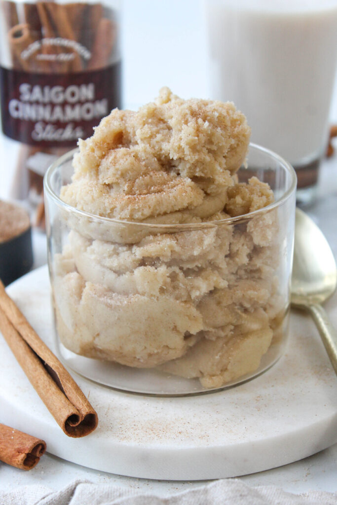 Bowl of edible snickerdoodle cookie dough with cinnamon‑sugar sprinkled on top