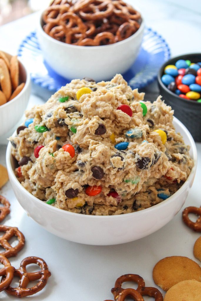 Creamy monster cookie dough dip topped with chocolate chips and colorful M&Ms